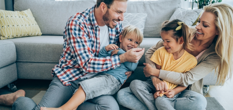 A Family sitting in front of the couch