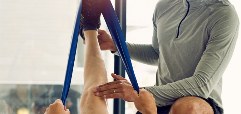 A therapist stretching a clients leg
