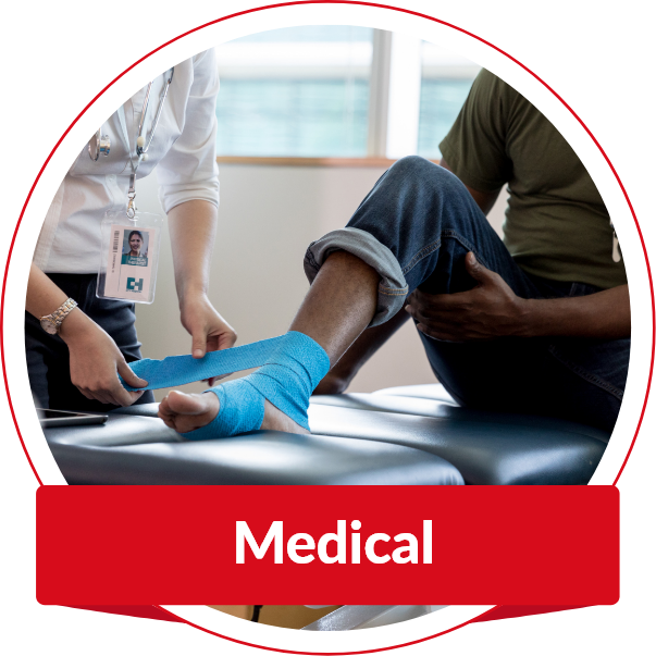 Healthcare professional applying a bandage to a patient’s ankle during a medical assessment.