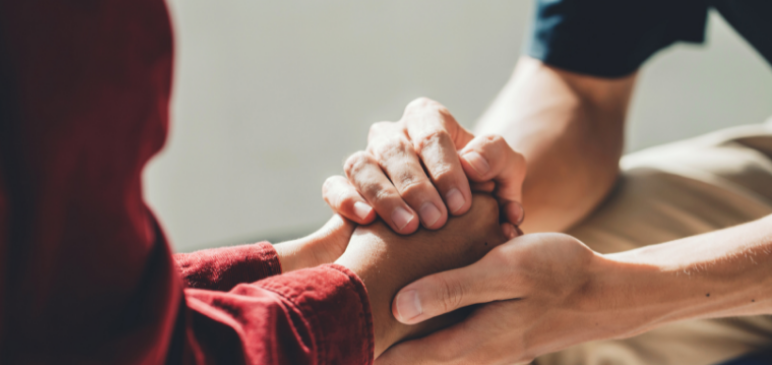 Two sets of hands holding eachother